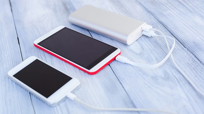 two smartphones connected to a power bank